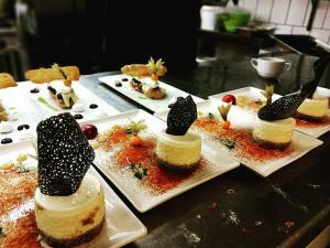 a bunch of desserts on plates on a table at Hotel Tókert Szálloda és Étterem in Lillafüred