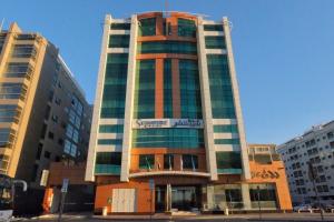 a tall building with a sign on the side of it at Signature Hotel Al Barsha in Dubai