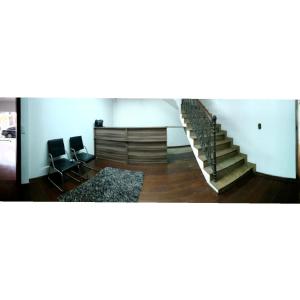 une chambre avec des chaises et des escaliers dans un bâtiment dans l'établissement Anexo São João, à Piracicaba