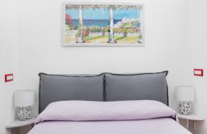 a bedroom with a bed and a picture on the wall at Capri Dreaming in Anacapri