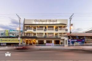 a building on the corner of a street at Orchard Hotel Davao in Davao City