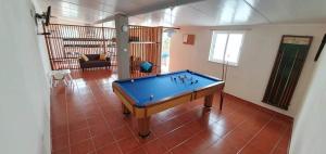 a pool table in the middle of a living room at Monte Família Ferreira in Vale de Açor