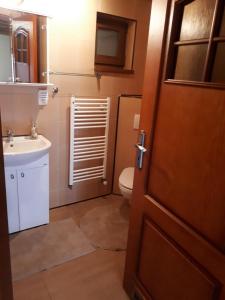 łazienka z toaletą, umywalką i drzwiami w obiekcie Apartmán Bianka w mieście Rabča