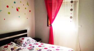 テーラス・デ・ボウロにあるCasa da Motaのベッドルーム1室(赤いカーテンと窓付きのベッド1台付)