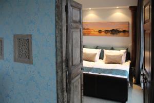 a bedroom with a bed and a painting on the wall at Atica Penthouse in Tallinn