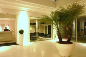 a lobby with two potted plants in a building at Home 15 Residence in Catania