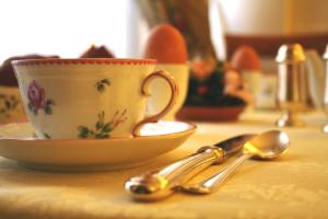 a cup and a bowl and spoons on a table at JOIVY Together Florence Secret Nest in Florence