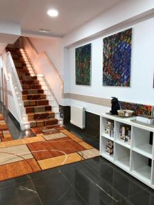 a room with stairs and paintings on the wall at Pensión Miribilla in Bilbao