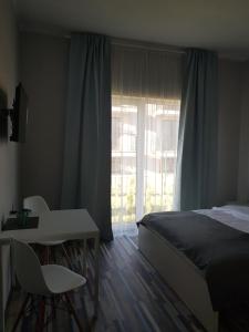 Postel nebo postele na pokoji v ubytování Willa Kardamon