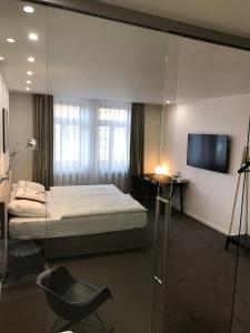 Posteľ alebo postele v izbe v ubytovaní Rozmaryn Hotel B&B