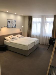 Posteľ alebo postele v izbe v ubytovaní Rozmaryn Hotel B&B