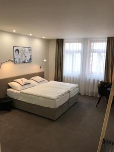 Posteľ alebo postele v izbe v ubytovaní Rozmaryn Hotel B&B