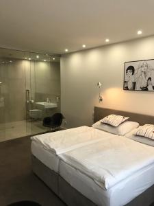 Posteľ alebo postele v izbe v ubytovaní Rozmaryn Hotel B&B