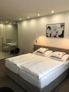 Posteľ alebo postele v izbe v ubytovaní Rozmaryn Hotel B&B