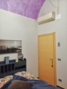 a bedroom with a purple ceiling and a door at Casa dei Mombri in Noli