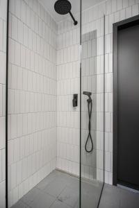 a shower with a shower head in a bathroom at AVA Apartments by Heimaleiga in Reykjavík