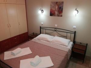 a bedroom with a bed with two towels on it at Villa Katerina Almyros in Almiros Beach