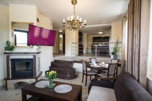 a living room with a couch and a fireplace at Apartamenty Ciche Wzgórze Zakopane in Zakopane