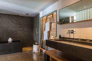 a bathroom with two sinks and a mirror at Hotel Christopher Saint Barth in Gustavia
