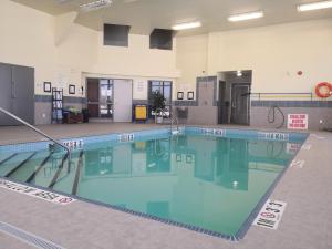 a large swimming pool with blue water in a building at Quality Inn & Suites in Hawkesbury