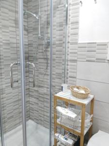 a shower in a bathroom with a glass shower stall at Appartamento Dammuso Isola Di Ortigia in Syracuse