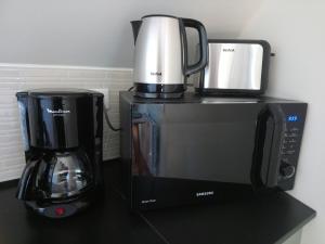 a coffee maker and a coffeemaker on a counter at Appartement Studio Prieuré in Quimper
