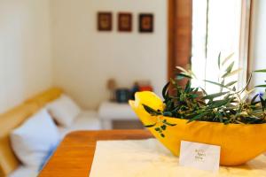 a yellow planter sitting on a table with a plant at Aperi View in Karpathos