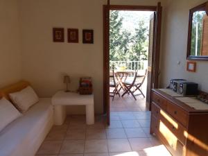 a living room with a bed and a couch and a table at Aperi View in Karpathos +33 photos