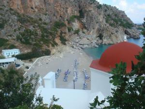 a view of a beach with blue boats on the water at Aperi View in Karpathos
