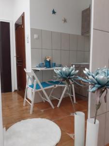 a kitchen with a table and chairs in a room at Fedra in Novi Sad