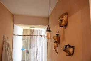 a bathroom with two masks hanging on the wall at B&B Big Sur in Gardone Riviera