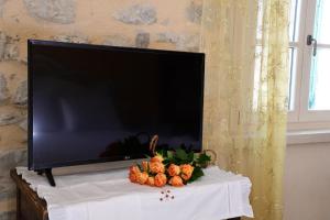 a flat screen tv sitting on a table with pumpkins at B&B Big Sur in Gardone Riviera