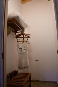 a dress hanging on a rack in a room at B&B Big Sur in Gardone Riviera