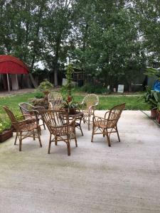 a group of chairs and a table with an umbrella at Casa Madonna Boschi in Poggio Renatico +13 photos