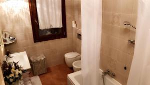 a bathroom with a toilet and a sink and a shower at Casa Madonna Boschi in Poggio Renatico