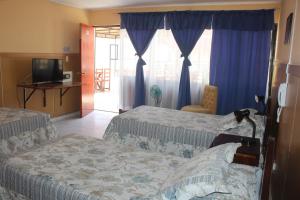 A bed or beds in a room at Hotel Sol de Arica