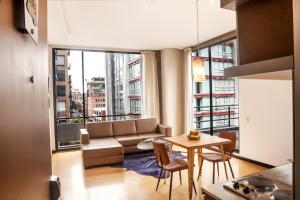 a living room with a couch and a table with chairs at Hotel Viaggio Nueve Tres in Bogotá