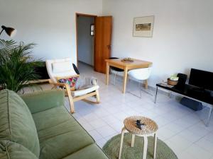a living room with a couch and a table at Casa VILA CEIXE in Odeceixe
