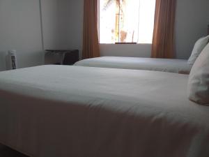 Postel nebo postele na pokoji v ubytování Hostal Vasco
