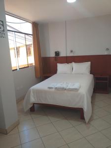 Postel nebo postele na pokoji v ubytování Hostal Vasco