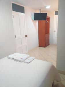 Postel nebo postele na pokoji v ubytování Hostal Vasco
