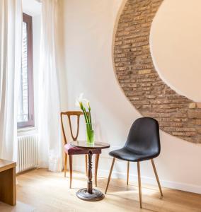 tavolo e sedia in una stanza con specchio di Tolomeo Apartment a Roma