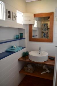 a bathroom with a sink and a mirror at BookingBoavista - Coral in Sal Rei
