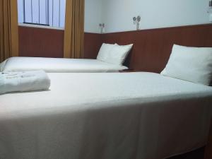 Postel nebo postele na pokoji v ubytování Hostal Vasco
