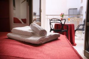 a pile of towels sitting on top of a table at Belle Epoque B&B in Trapani