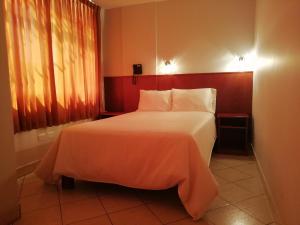 Postel nebo postele na pokoji v ubytování Hostal Vasco