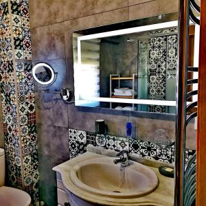 a bathroom with a sink and a mirror at NorbeHouse in Zamora