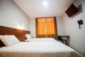 Postel nebo postele na pokoji v ubytování Hostal Vasco