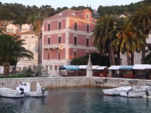 a group of boats in the water in front of a building at Novak Bonaparte - Hvar city center in Hvar