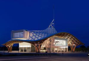 a building with a pointed roof at night at L'appart Moulin des Thermes Metz in Metz